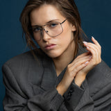 Fonda Gun Metal Optical by Tribu Eyewear — Fine wire metal frame on women's face, studio view.