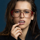 The DON Optical by Tribu Eyewear — Deep Red on Smoke Aviator frame, model wearing studio lighting.