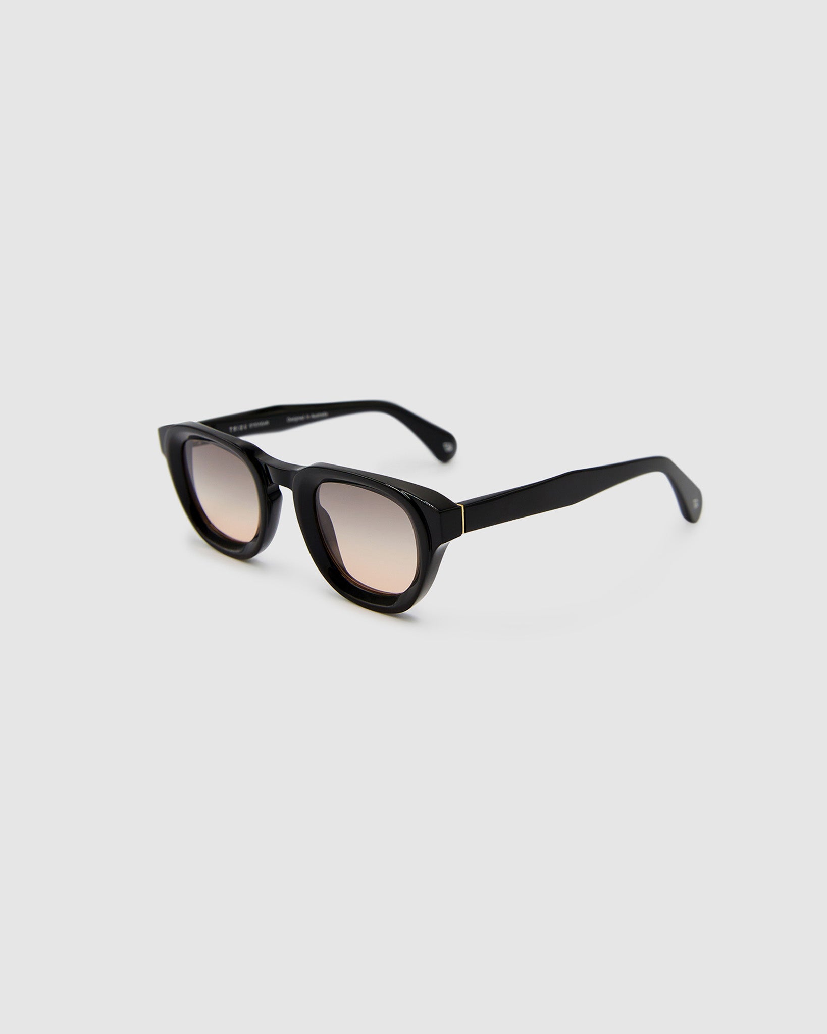 Brutal 4.0 Sunglasses by Tribu Eyewear — Black round acetate frame, dusk lens, side view light grey background.