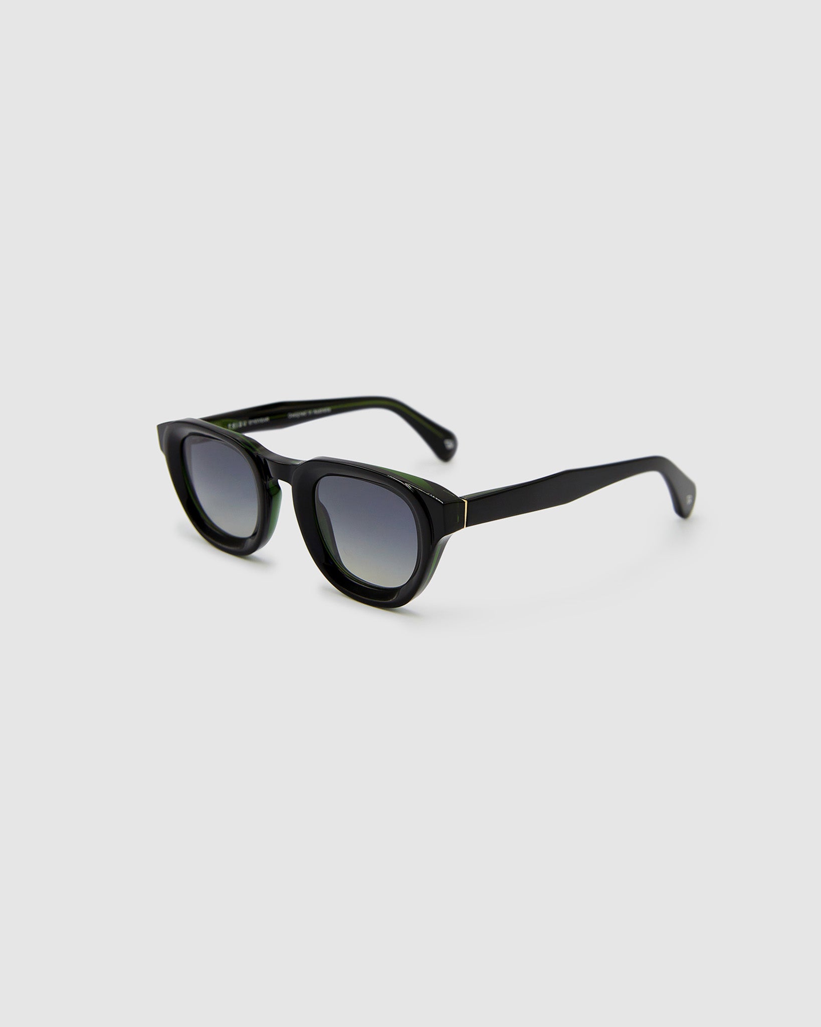 Brutal 4.0 Polarised Sunglasses by Tribu Eyewear — Black Round acetate frame, grey grad lens, side view light grey background.