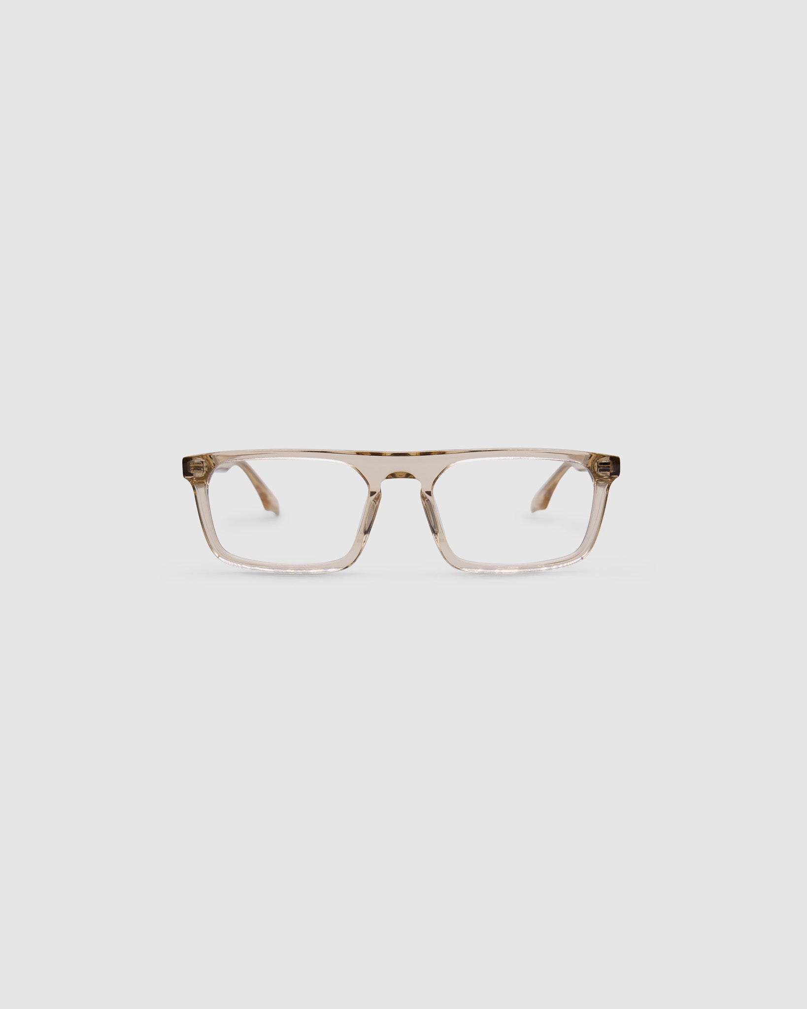 Gentleman Optical by Tribu Eyewear — champagne crystal rectangular optical frame, front view on a grey background. 