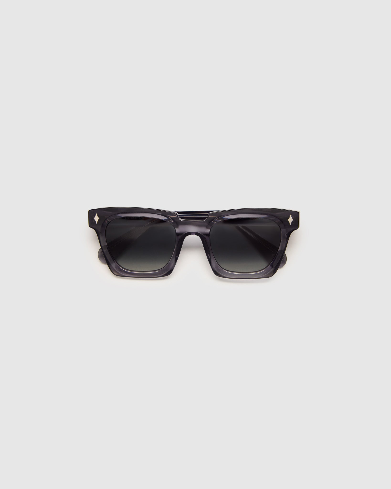 Brutal 1.0 Polarised Sunglasses by Tribu Eyewear — Smoke rectangular acetate frame, grey grad lens, flat view light grey background.