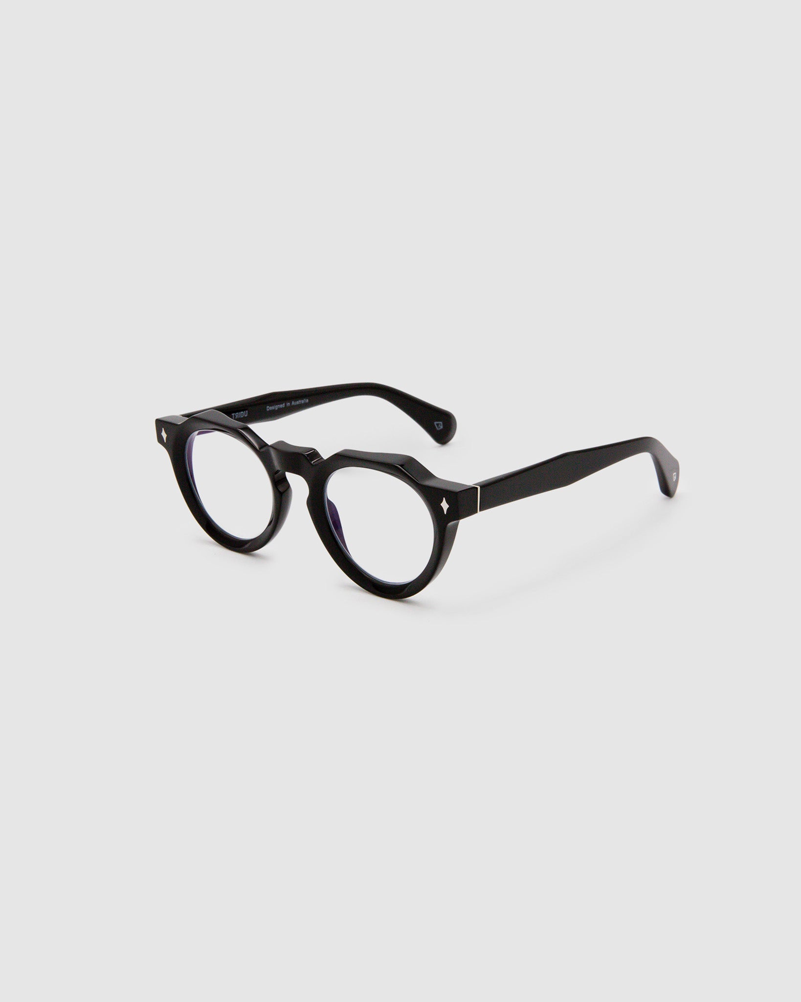 Brutal 2.0 Optical by Tribu Eyewear — Black round optical frame, side view studio lighting. 