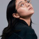 Brutal 2.0 Optical by Tribu Eyewear — Champagne Crystal round optical frame, female model studio lighting. 