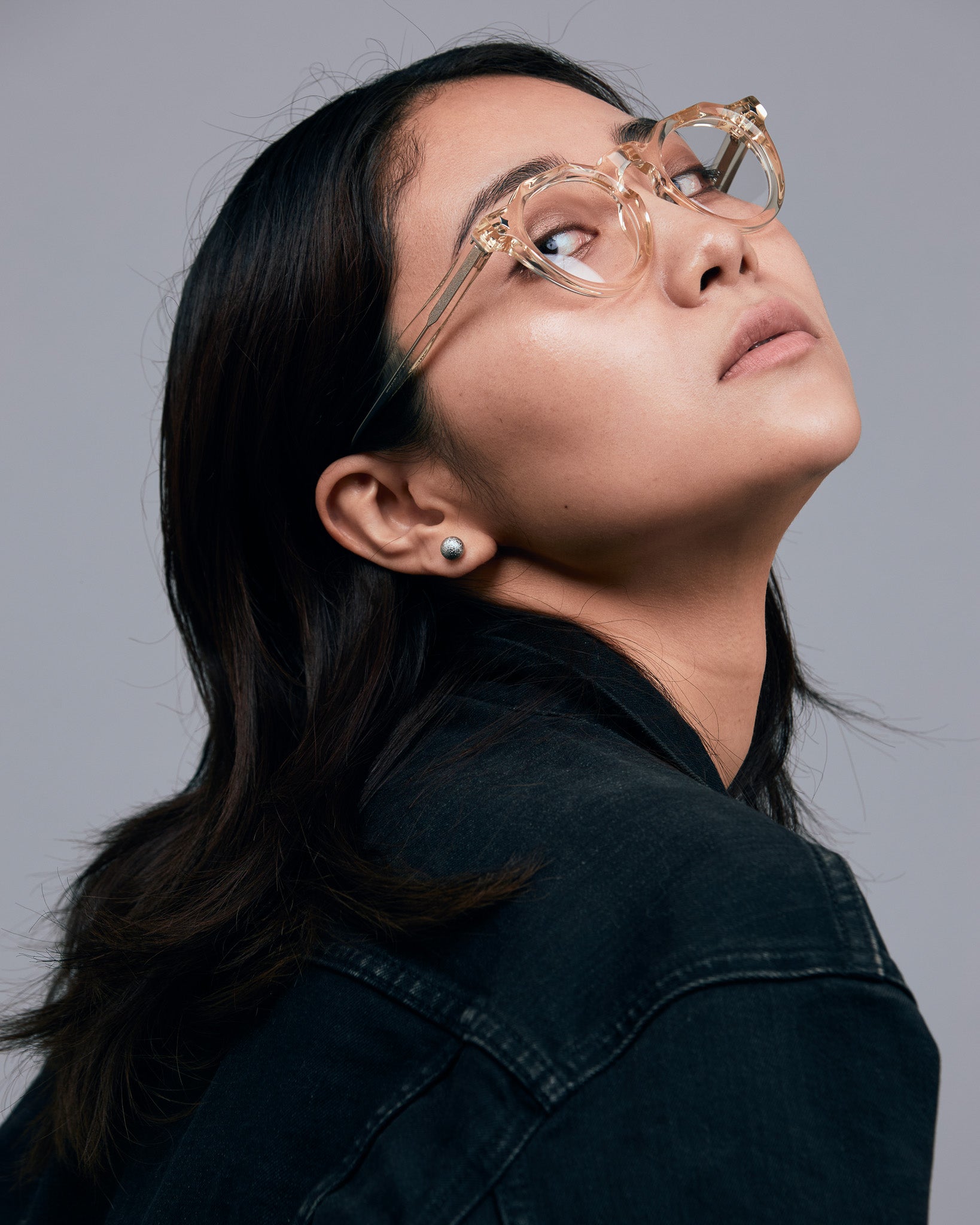 Brutal 2.0 Optical by Tribu Eyewear — Champagne Crystal round optical frame, female model studio lighting. 