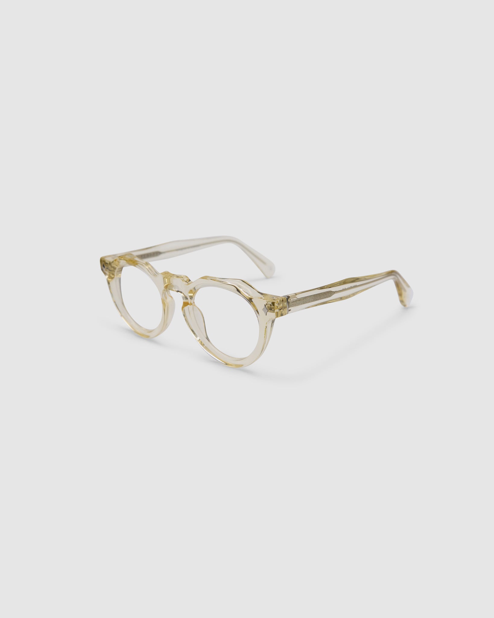 Brutal 2.0 Optical by Tribu Eyewear — Champagne Crystal round optical frame, side view studio lighting. 