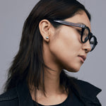 Brutal 2.0 Optical by Tribu Eyewear — Tortoiseshell round optical frame, female model side view studio lighting. 