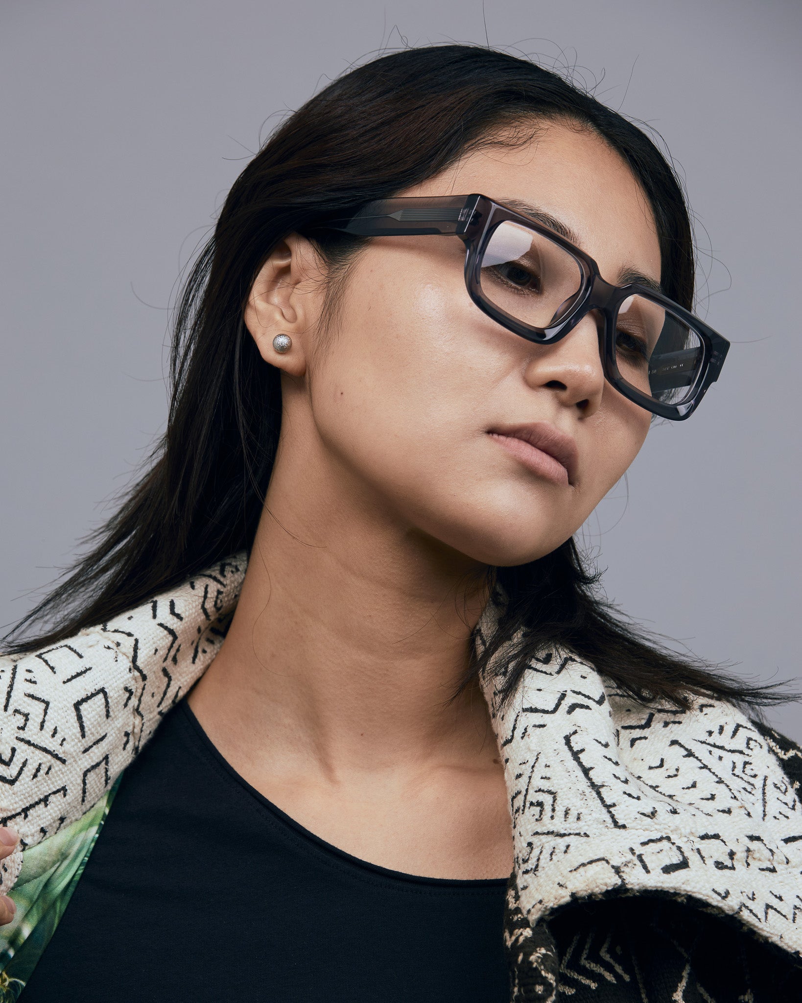 Brutal 3.0 Optical by Tribu Eyewear — Smoke Crystal square optical frame, female model studio lighting. 