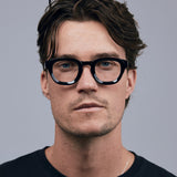 Brutal 4.0 Optical by Tribu Eyewear — Black round optical frame, male model  studio lighting. 