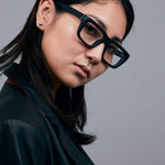 Brutal 5.0 Optical by Tribu Eyewear — Matte Black square optical frame, female model against a grey background. 