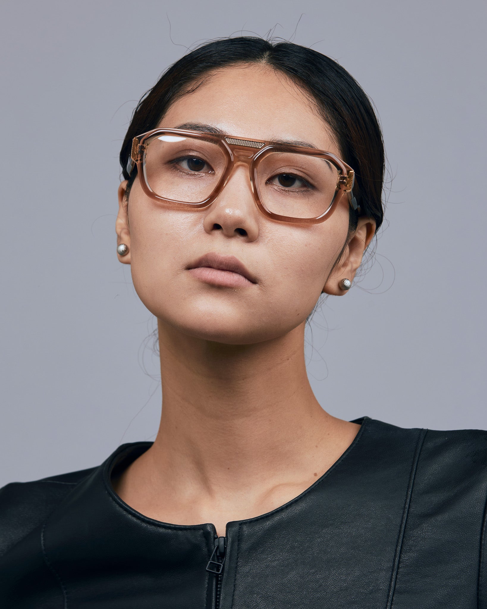 Marley Optical by Tribu Eyewear — Champagne crystal acetate aviator optical frame, female model against a grey background. 