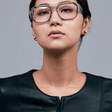 Marley Optical by Tribu Eyewear — Smoke crystal acetate aviator optical frame, female model against a grey background. 