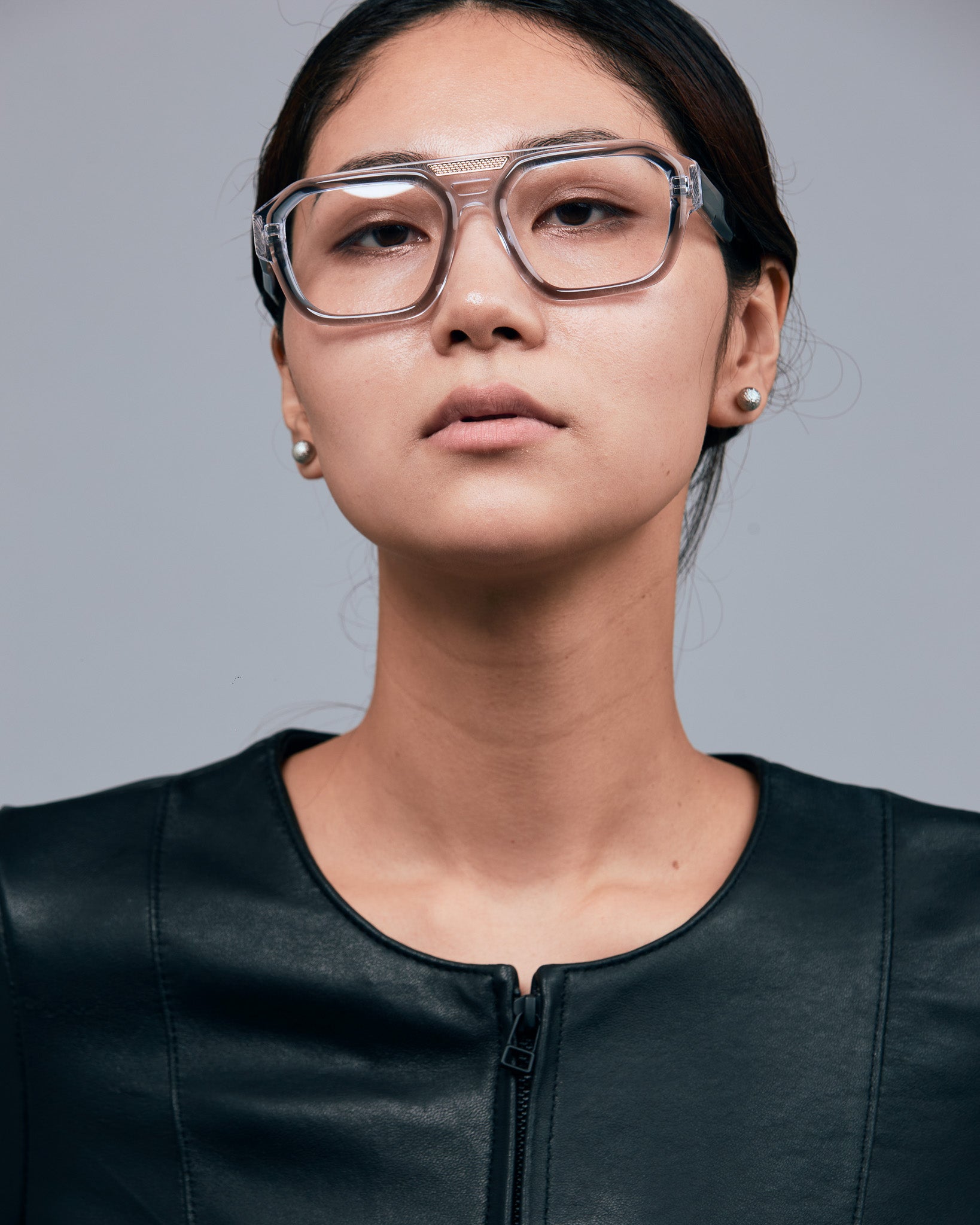 Marley Optical by Tribu Eyewear — Smoke crystal acetate aviator optical frame, female model against a grey background. 