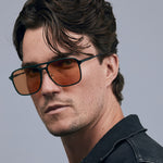 Oscar Sunglasses by Tribu Eyewear — Forest Green Aluminium Aviator frame, Desert Orange lens male model against white background.