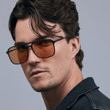 Oscar Sunglasses by Tribu Eyewear — Forest Green Aluminium Aviator frame, Desert Orange lens male model against white background.