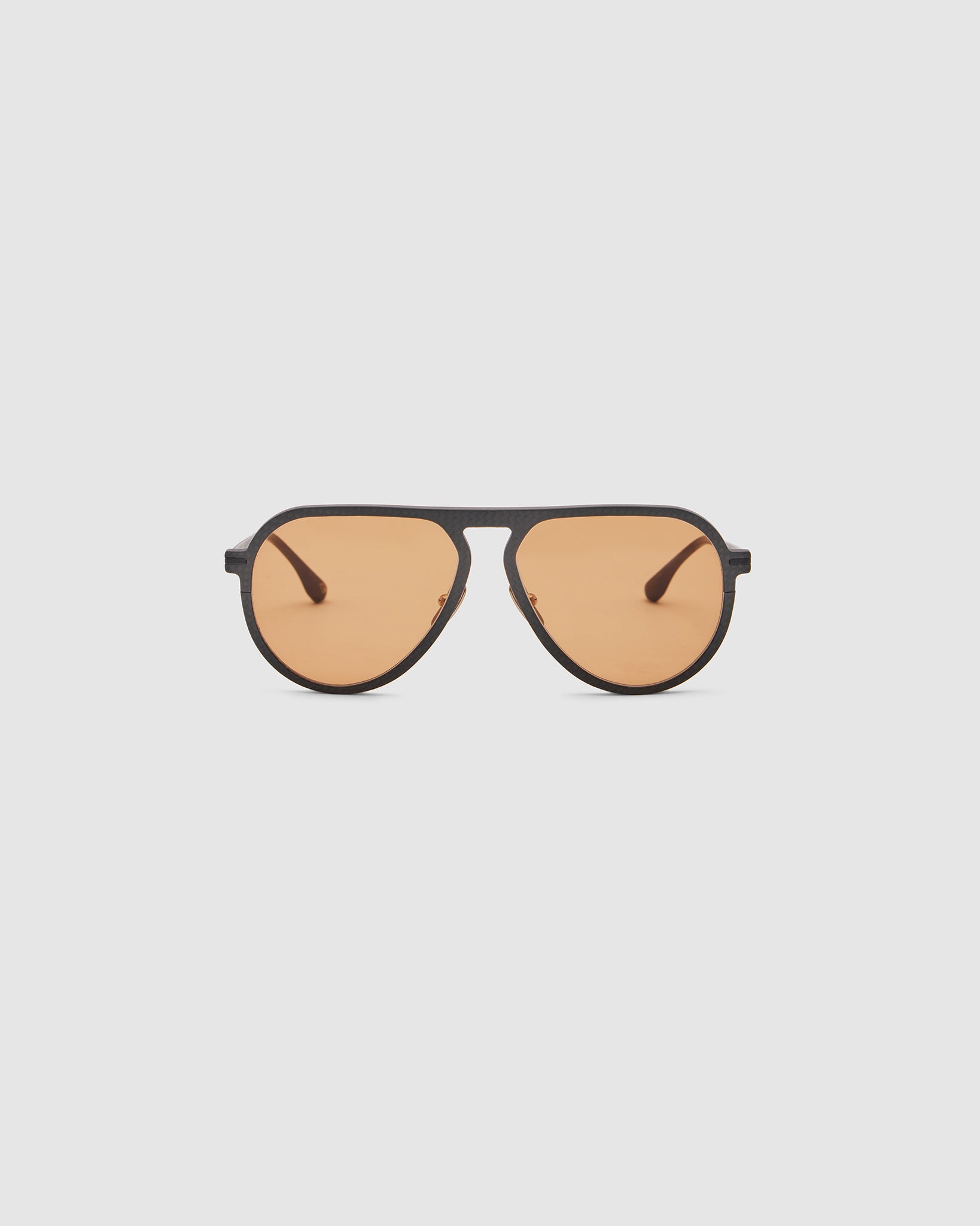 TRIBU Carbon 1.0 Black carbon fibre sunglasses with desert orange lenses, front view.