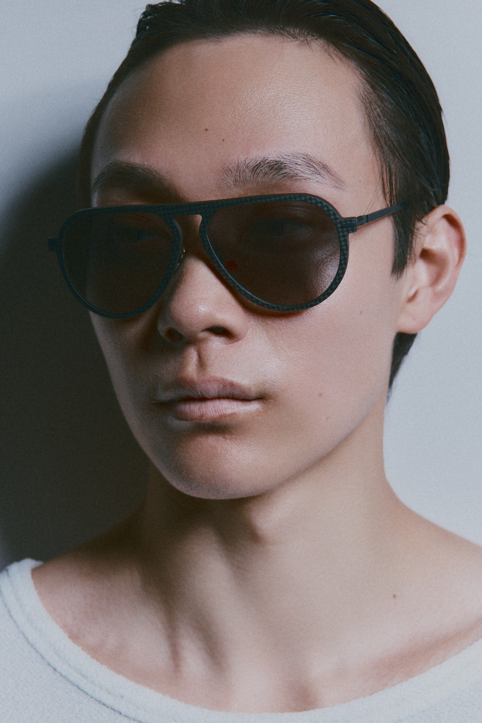 Model wearing TRIBU Carbon 1.0 black carbon aviator sunglasses - side view 