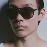 Model wearing TRIBU Carbon 1.0 black carbon aviator sunglasses - side view 