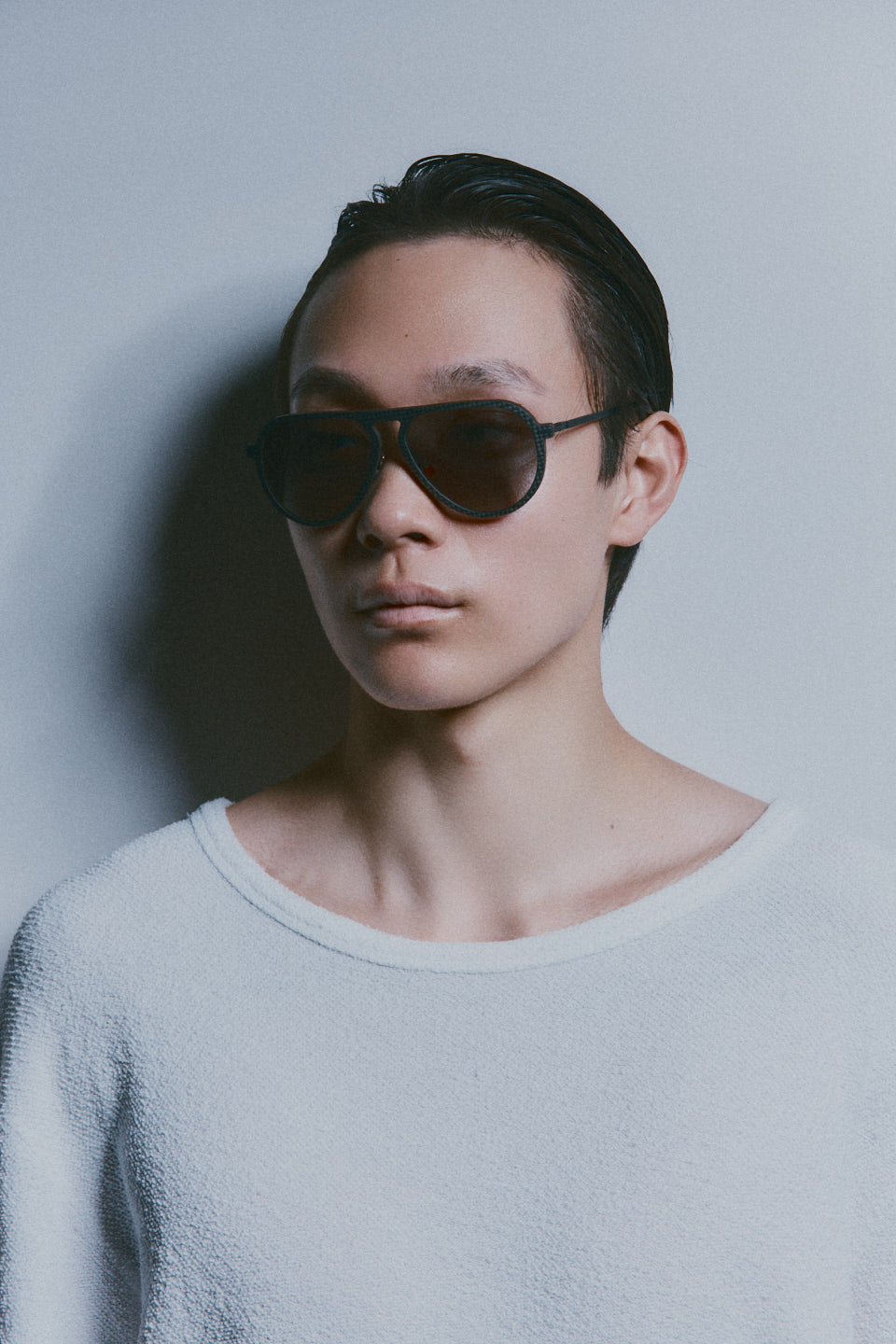 Model wearing TRIBU Carbon 1.0 black carbon aviator sunglasses - side view 