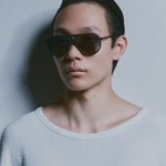 Model wearing TRIBU Carbon 1.0 black carbon aviator sunglasses - side view 