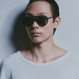 Model wearing TRIBU Carbon 1.0 black carbon aviator sunglasses - side view 