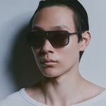 Model wearing TRIBU Carbon 2.0 gun carbon fibre square aviator sunglasses - side view 