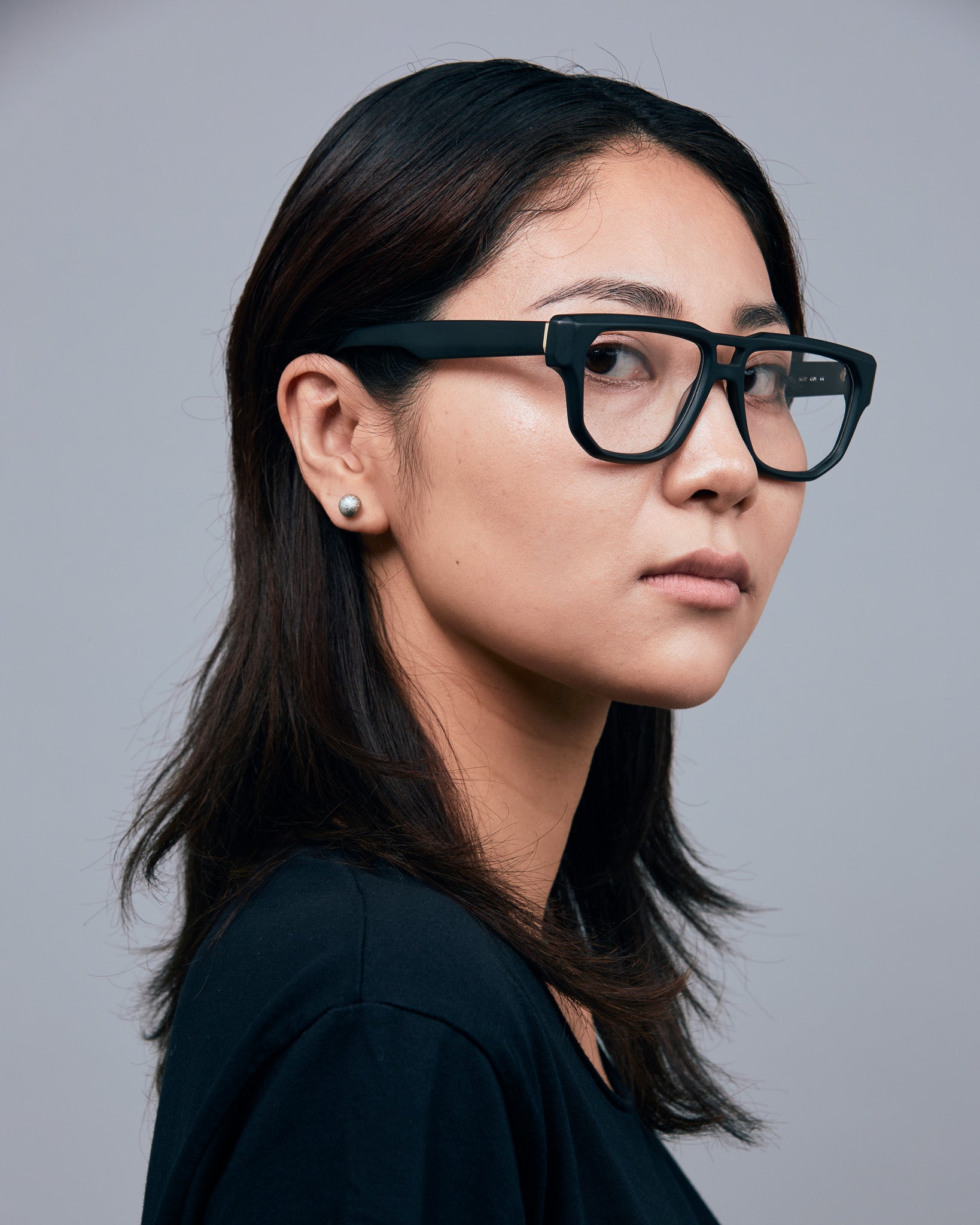Billie Optical by Tribu Eyewear — Matte Black Aviator optical frame, female model studio lighting. 