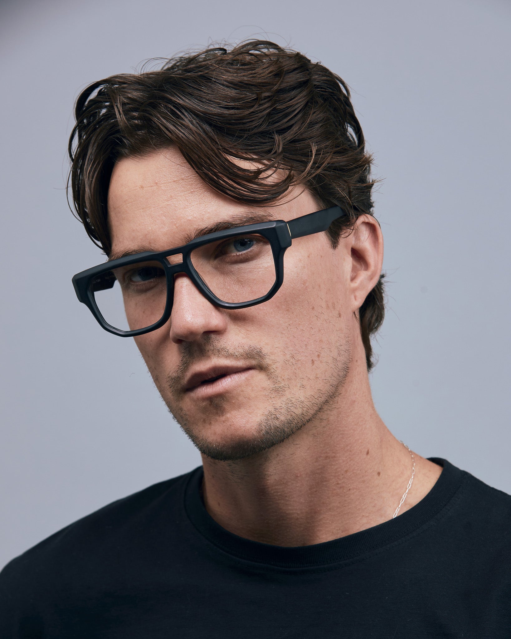 Billie Optical by Tribu Eyewear — Matte Black Aviator optical frame, male model studio lighting. 