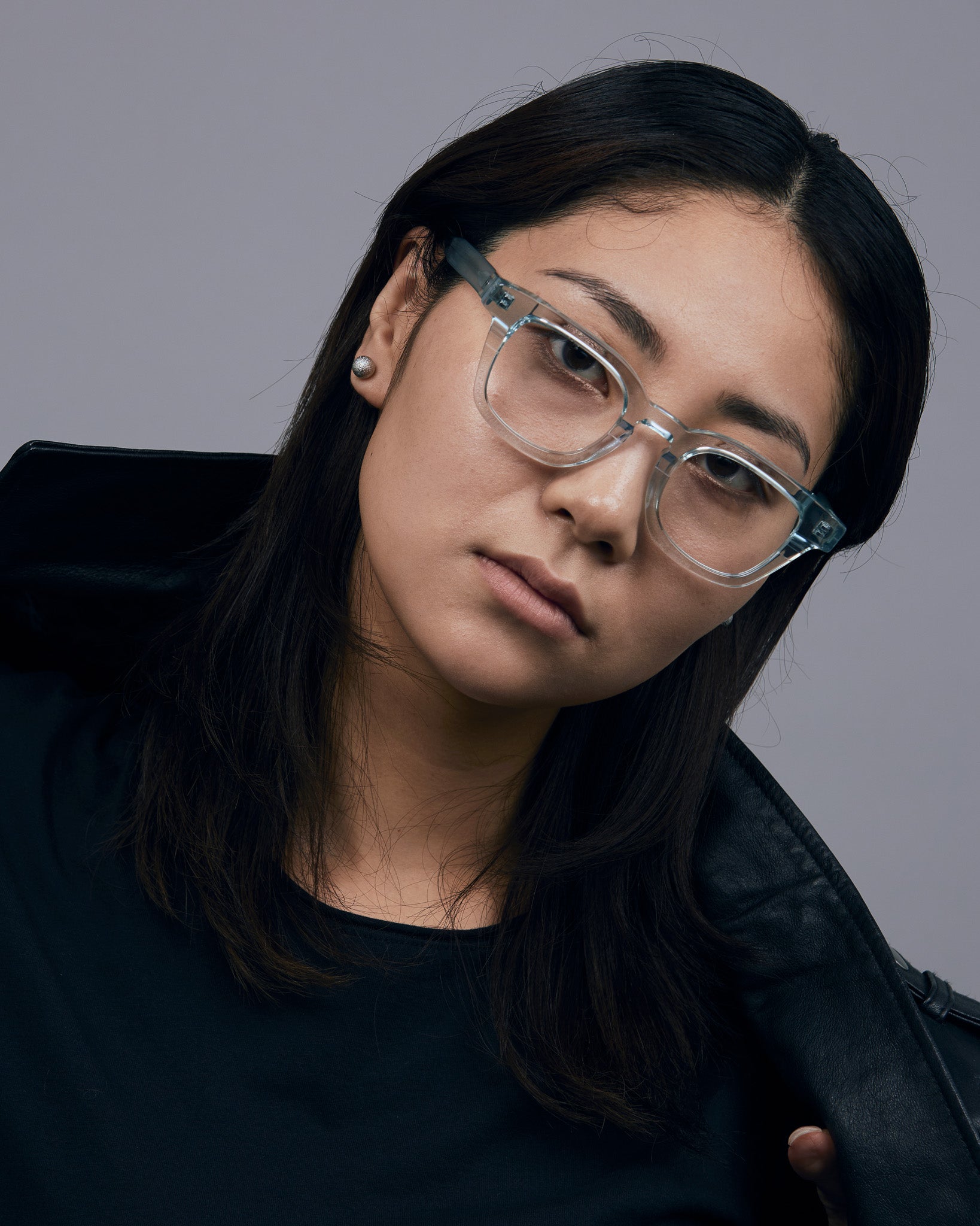 Bowie Optical by Tribu Eyewear — Baby Blue Crystal optical frame, female model studio lighting. 