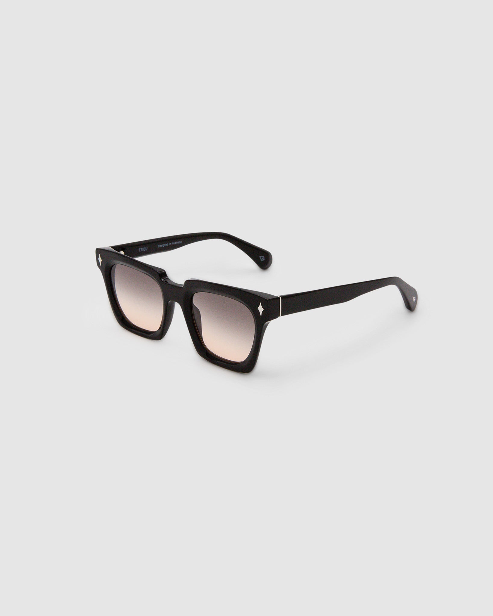 Brutal 1.0 Sunglasses by Tribu Eyewear — Black acetate square frame, dusk lens, side view, grey background.