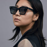 Brutal 1.0 Sunglasses by Tribu Eyewear — Champagne crystal acetate square frame, grey gradient polarised worn by female model.