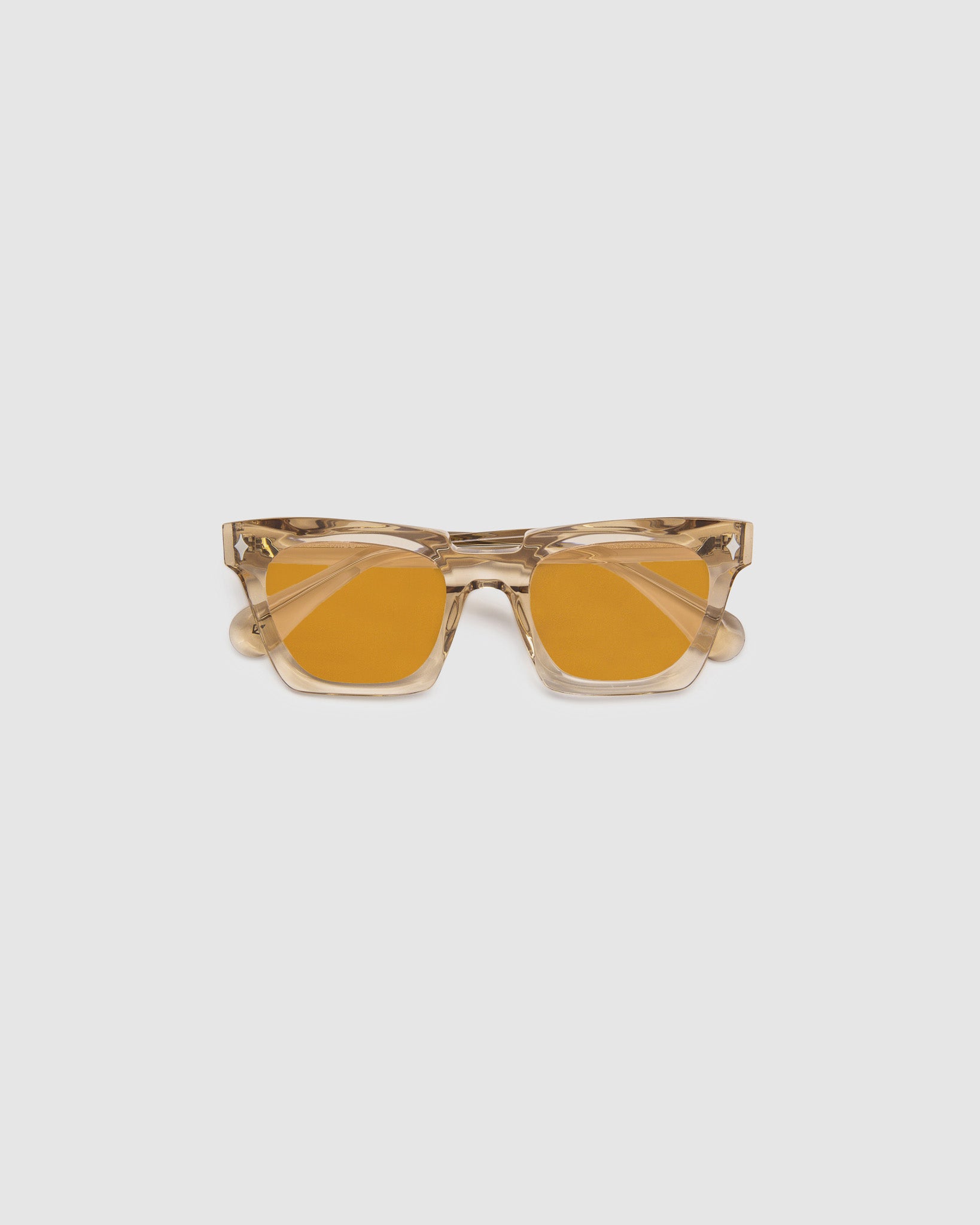Brutal 1.0 Sunglasses by Tribu Eyewear — Champagne crystal acetate square frame, desert orange tint lens, flat view, grey background.