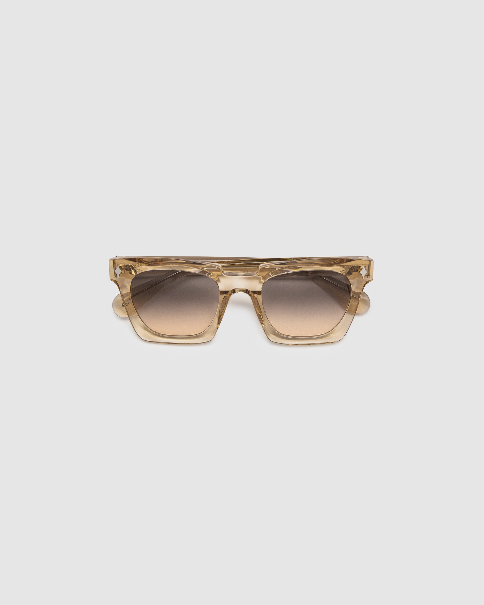 Brutal 1.0 Sunglasses by Tribu Eyewear — Champagne crystal acetate square frame, dusk tint lens, flat view, grey background.