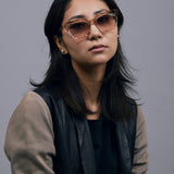 Brutal 1.0 Sunglasses by Tribu Eyewear — Champagne crystal acetate square frame, dusk tint lens, female model, grey background.