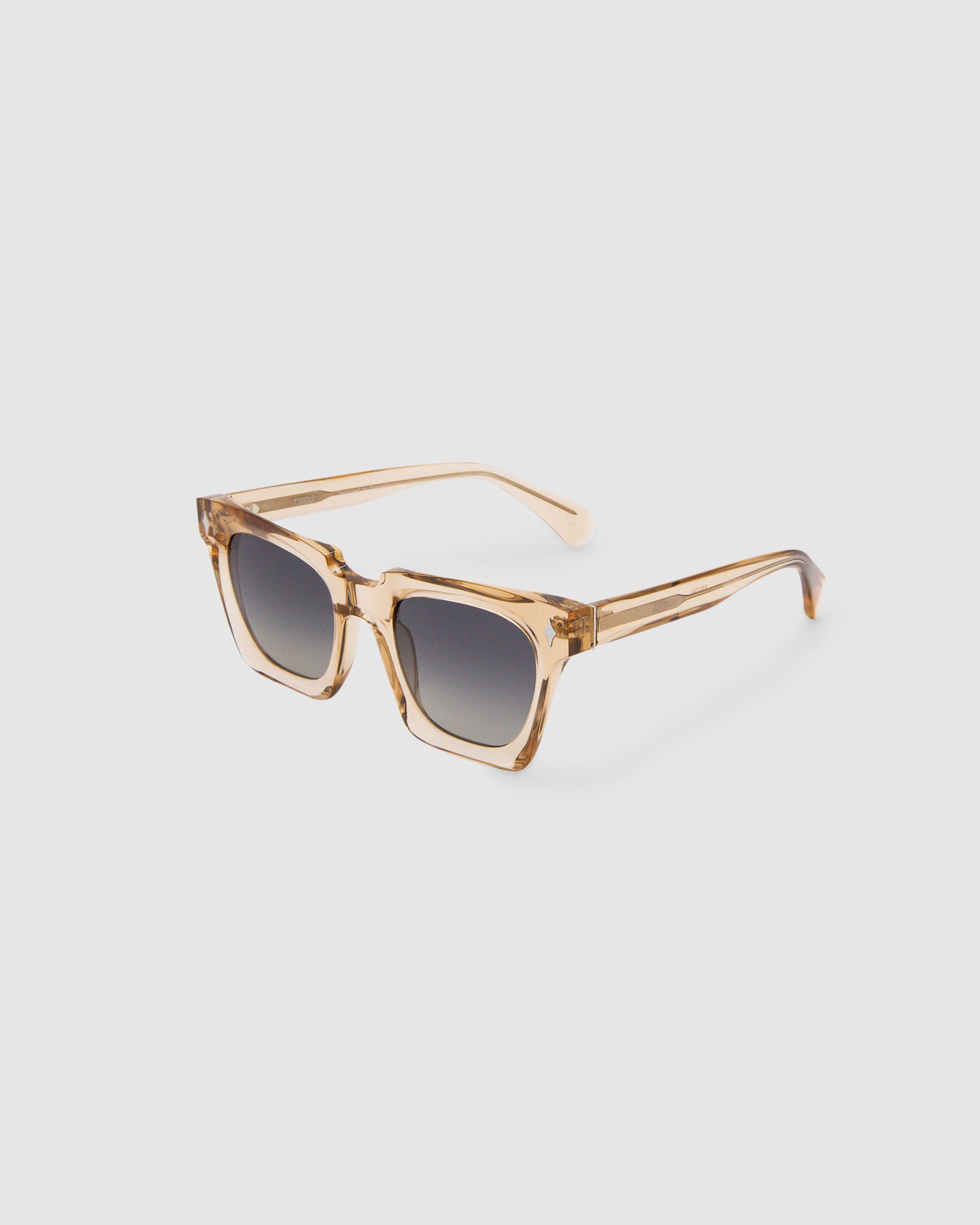 Brutal 1.0 Sunglasses by Tribu Eyewear — Champagne crystal acetate square frame, grey gradient polarised lens detailed view on white background.
