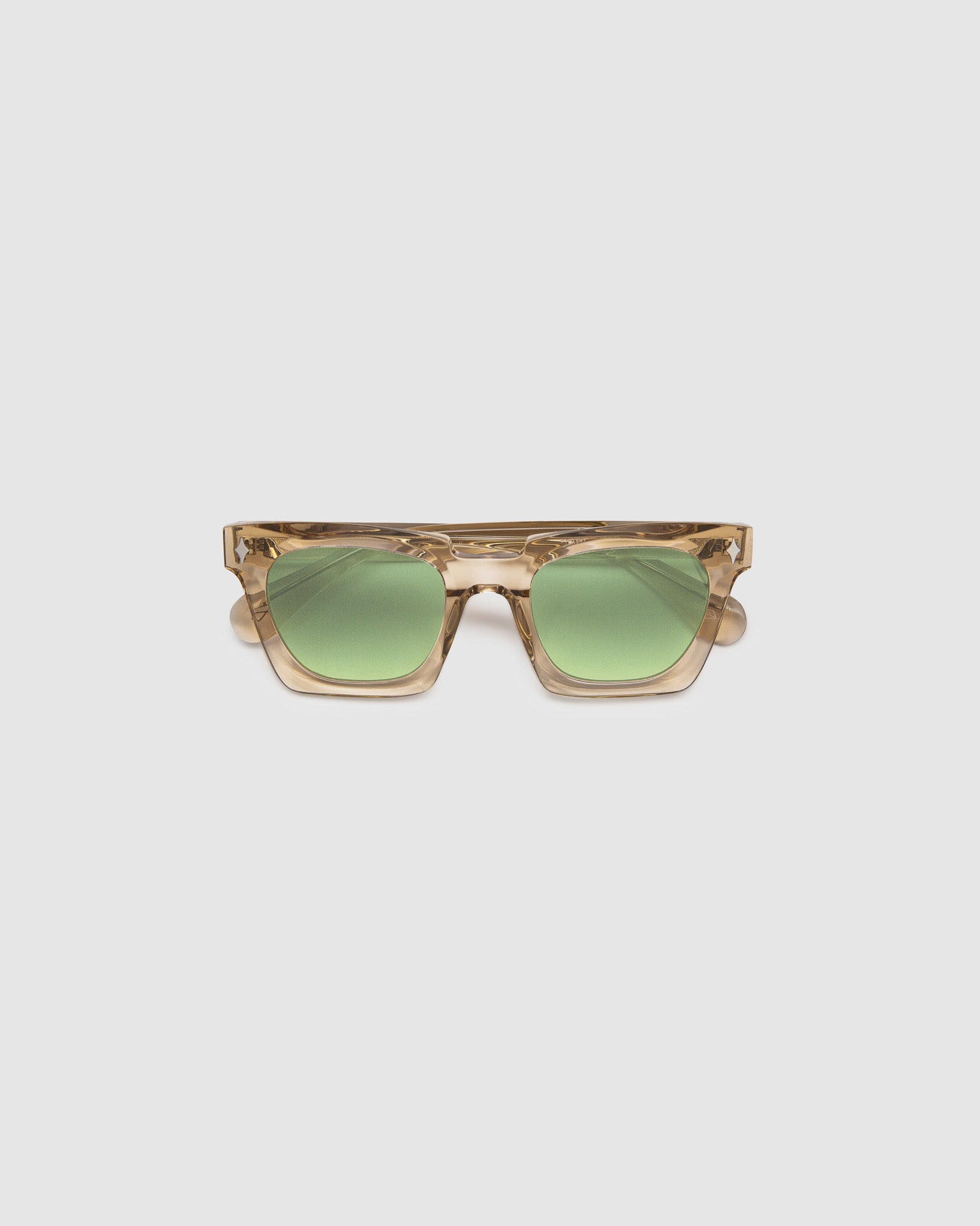 Brutal 1.0 Sunglasses by Tribu Eyewear — Champagne crystal acetate square frame, sage lens, flat view, grey background.