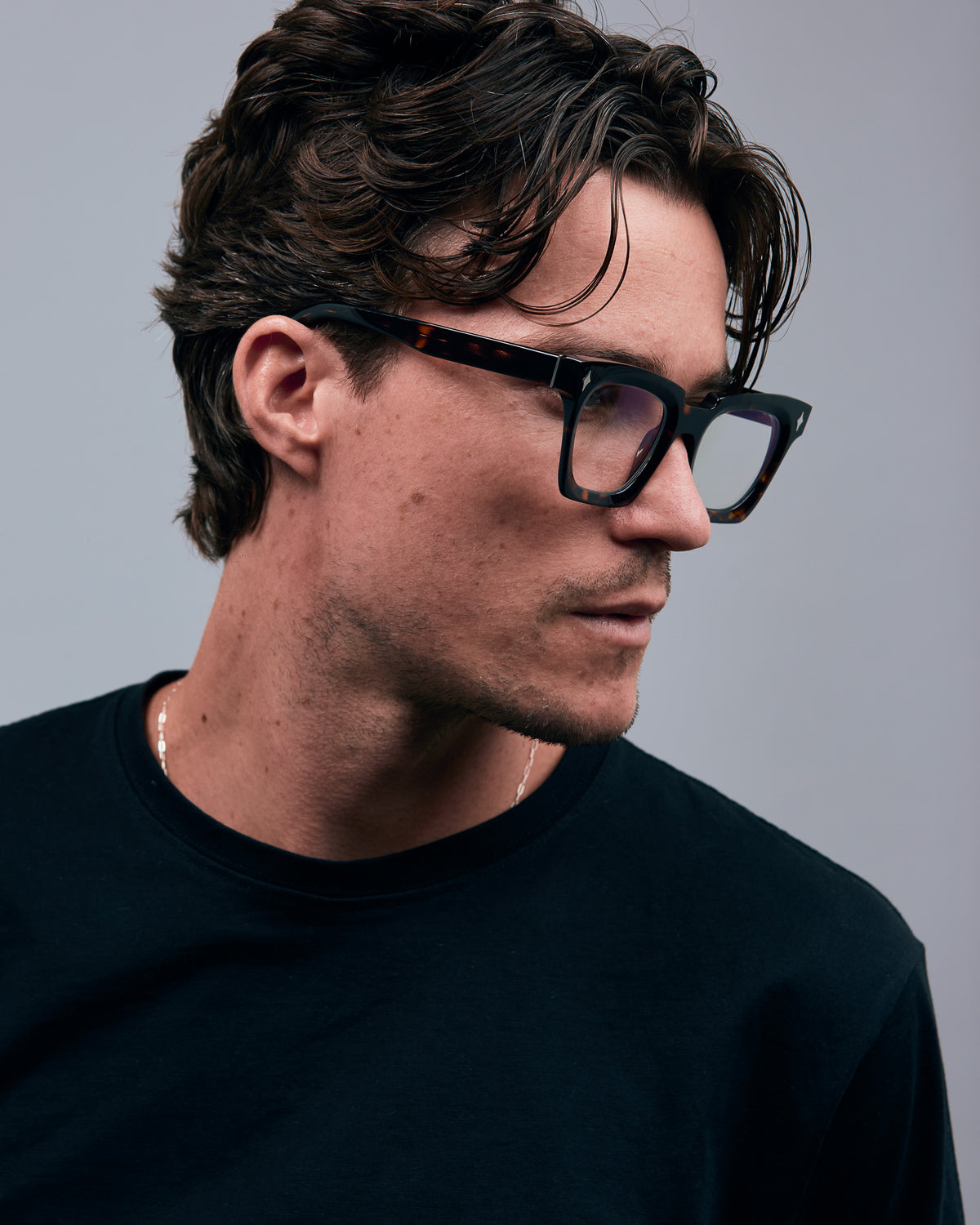 Brutal 1.0 Optical by Tribu Eyewear — Tortoiseshell square optical frame, male model side view in studio lighting. 