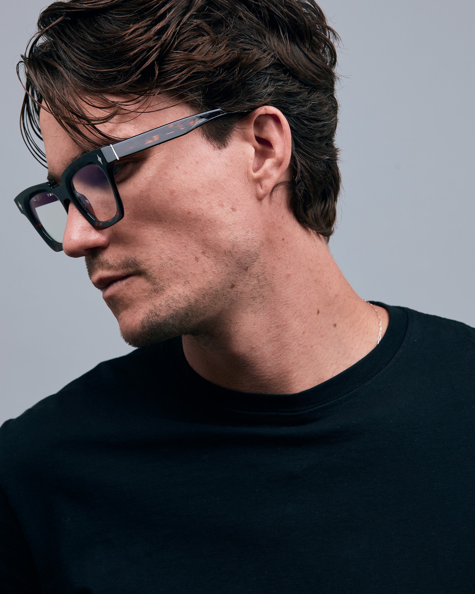 Brutal 1.0 Optical by Tribu Eyewear — Tortoiseshell square optical frame, male model side view in studio lighting. 