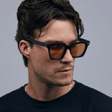 Brutal 1.0 Sunglasses by Tribu Eyewear — Tort acetate square frame, desert orange  lens on male model grey background.