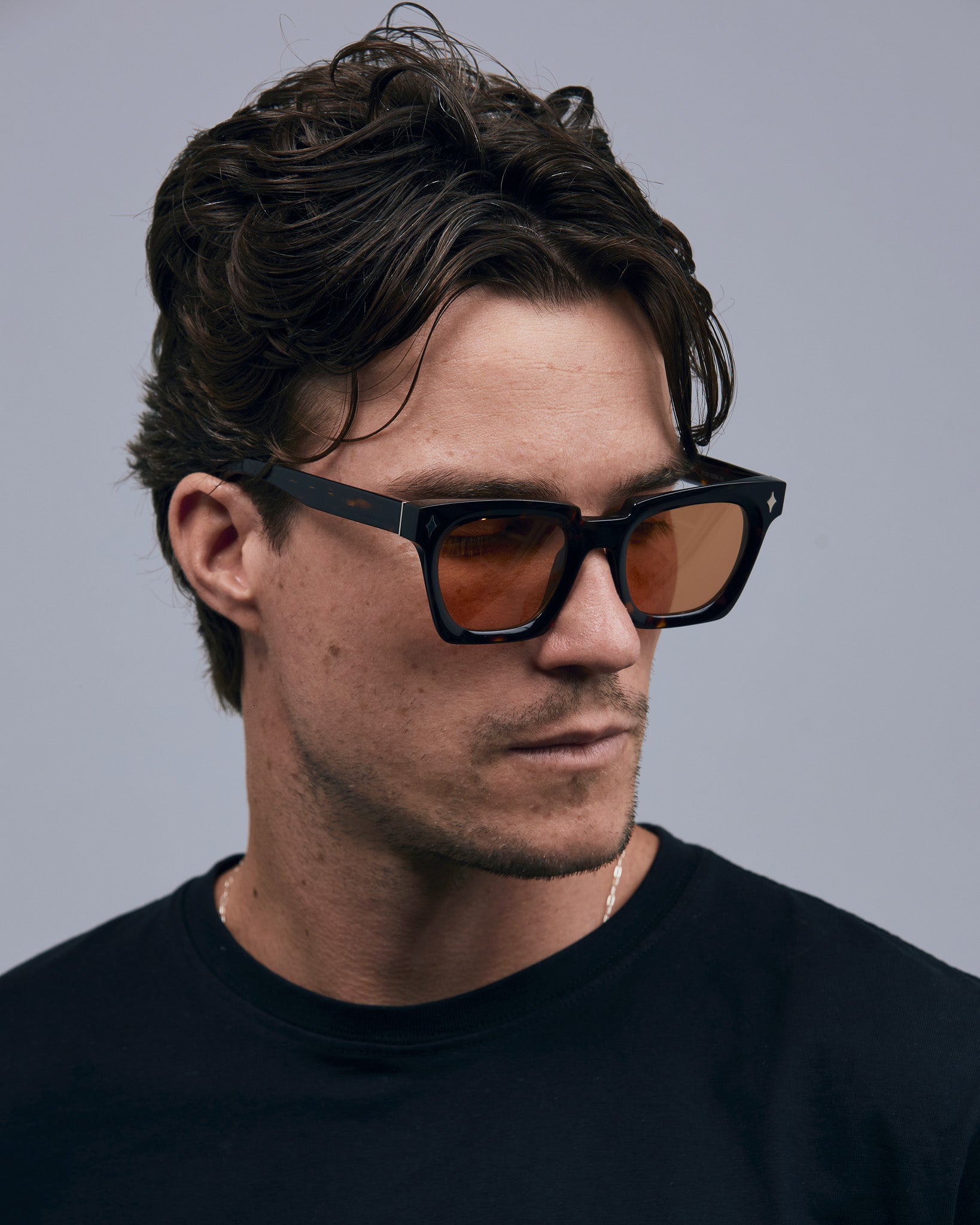 Brutal 1.0 Sunglasses by Tribu Eyewear — Tort acetate square frame, desert orange  lens on male model grey background.