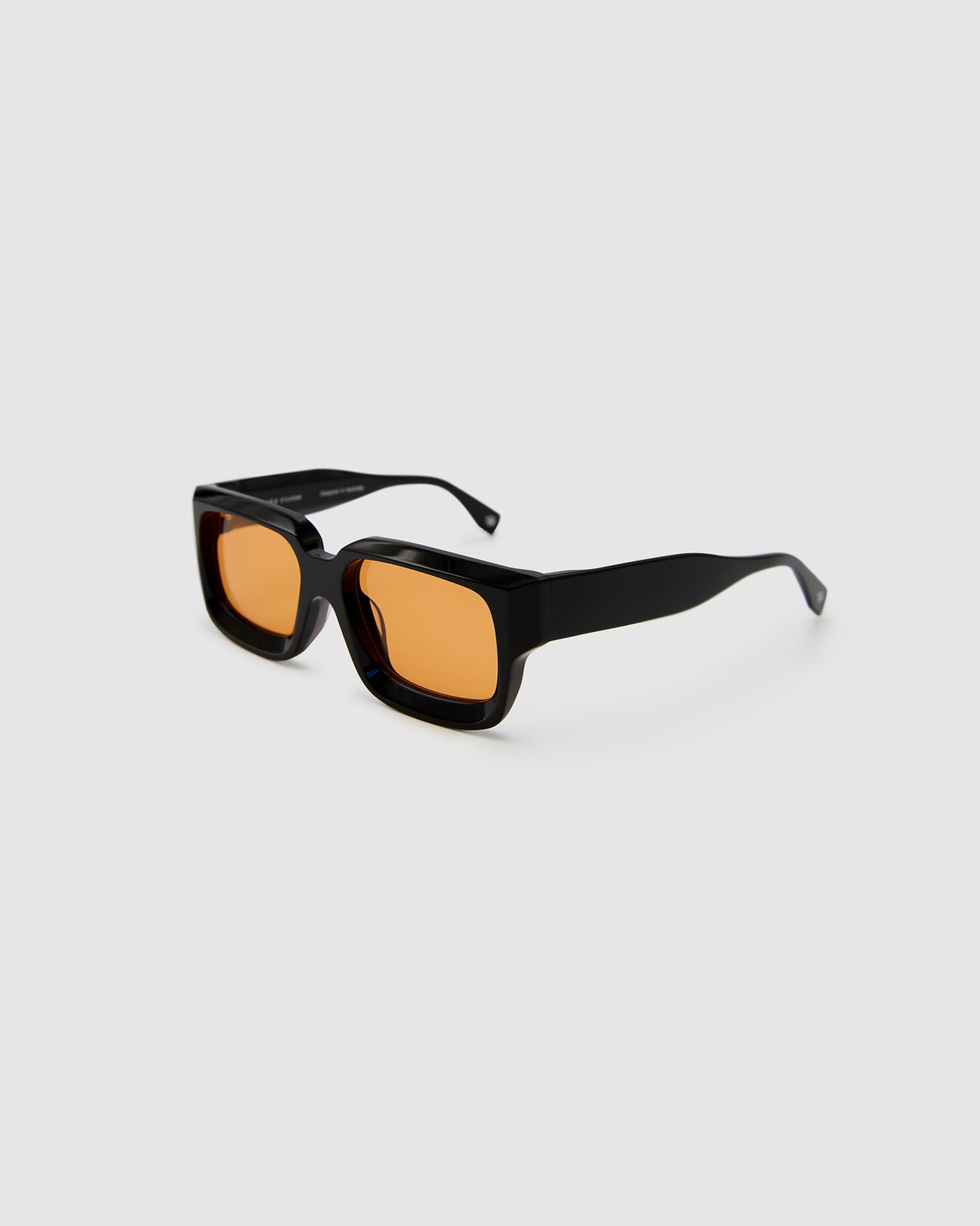 Brutal 3.0  Sunglasses by Tribu Eyewear — Black square acetate frame, Desert Orange lens, side view light grey background.