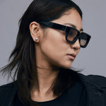 Brutal 3.0  Sunglasses by Tribu Eyewear — Black square acetate frame, dusk lens, on female model light grey background.