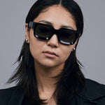 Brutal 3.0 Polarised Sunglasses by Tribu Eyewear — Black square frame, front view female model light grey background.