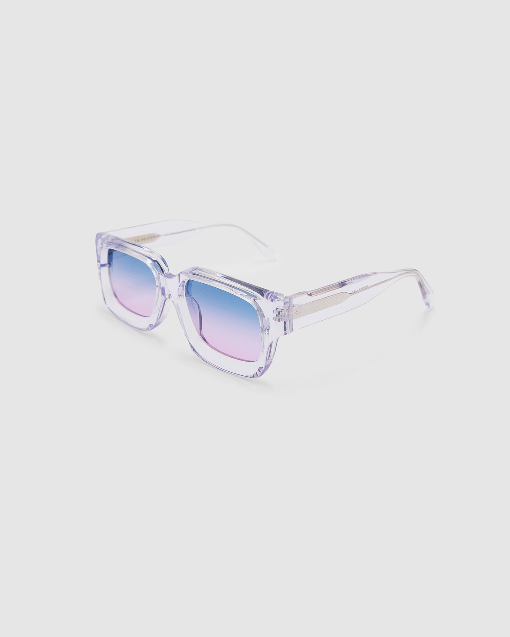 Brutal 3.0 Crystal Sunglasses by Tribu Eyewear — Crystal square acetate frame, Deep Ocean lens, side view light grey background.