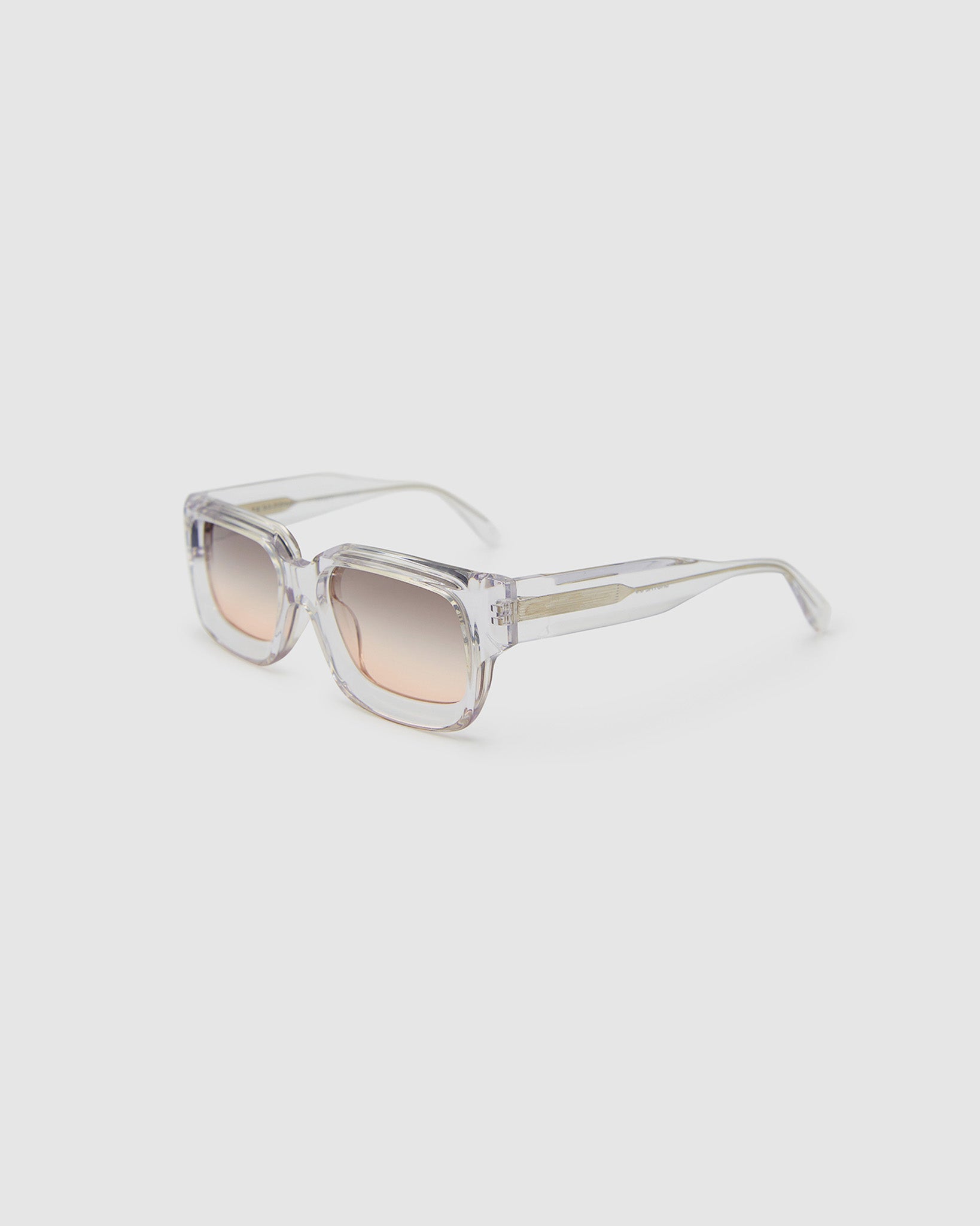Brutal 3.0  Sunglasses by Tribu Eyewear — Crystal square acetate frame, dusk lens, side view light grey background.