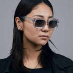 Brutal 3.0 Polarised Sunglasses by Tribu Eyewear — Crystal square acetate frame, female model light grey background.