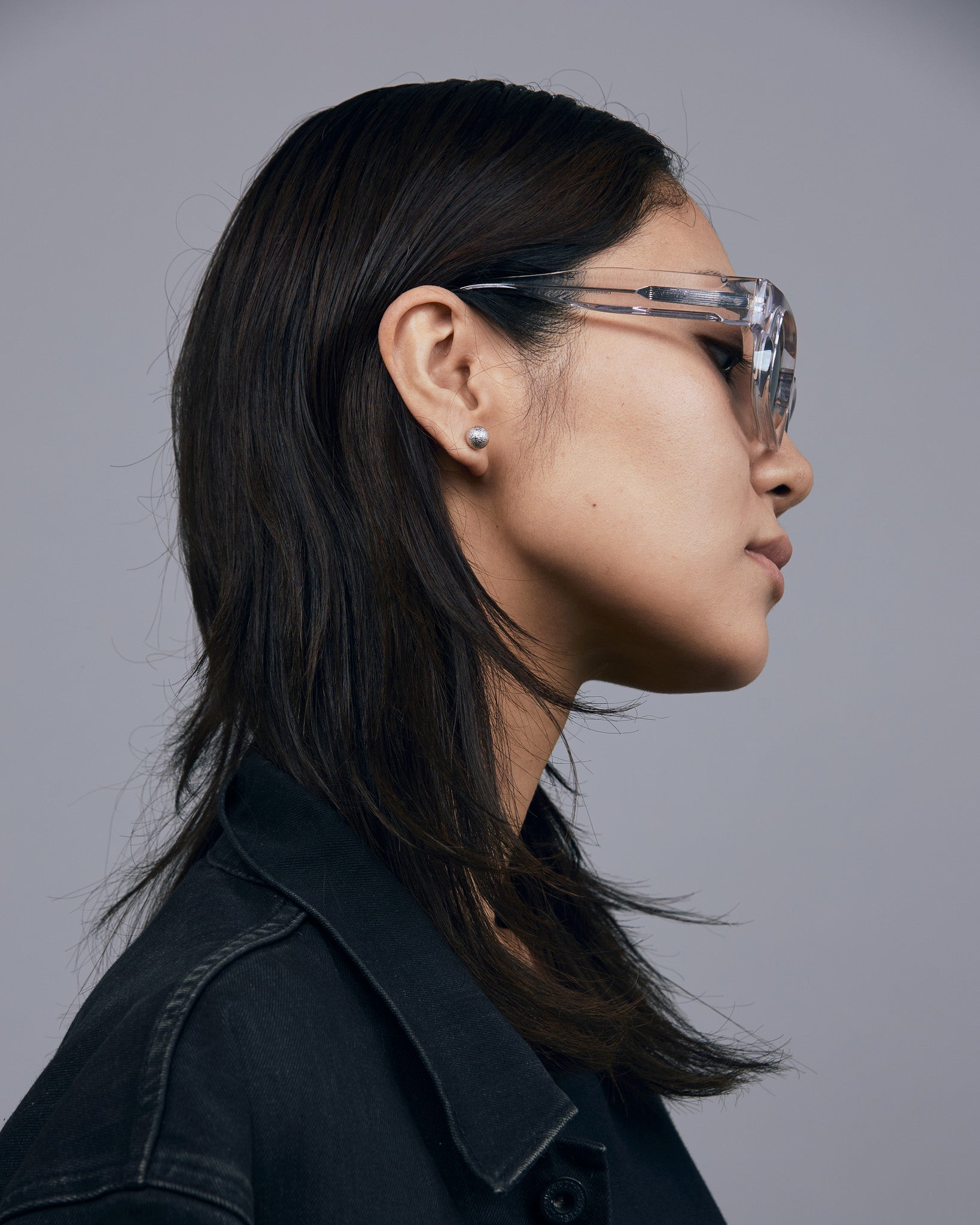 Brutal 3.0 Polarised Sunglasses by Tribu Eyewear — Crystal square acetate frame, side view, female light grey background.