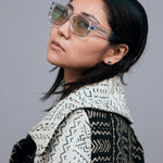 Brutal 3.0  Sunglasses by Tribu Eyewear — Crystal square acetate frame, sage lens, female model light grey background.