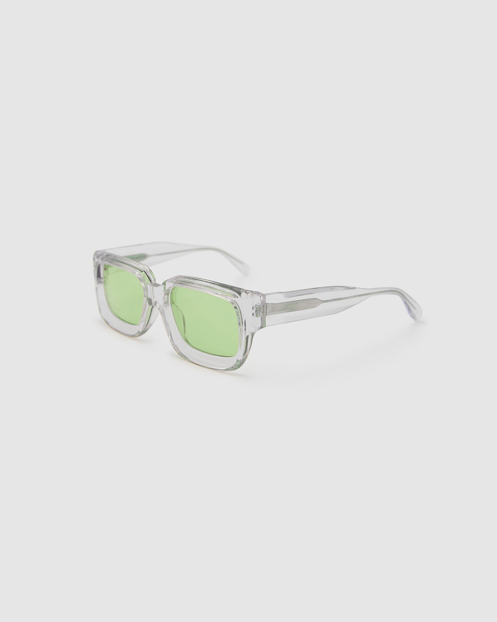 Brutal 3.0  Sunglasses by Tribu Eyewear — Crystal square acetate frame, sage lens, side view light grey background.
