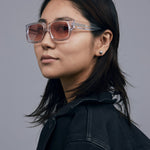 Brutal 3.0  Sunglasses by Tribu Eyewear — Crystal square acetate frame, sunset lens, female model light grey background.